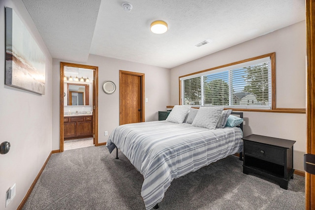1527 Wiersma Dr, Zeeland, MI 49464 - carpeted bedroom with ensuite bathroom and a textured ceiling