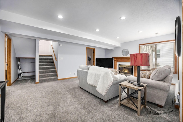 1527 Wiersma Dr, Zeeland, MI 49464 - living area with recessed lighting, carpet flooring, a glass covered fireplace, and stairs