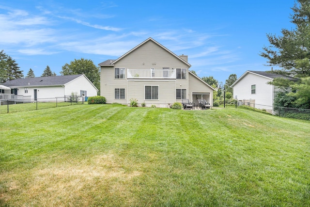 1527 Wiersma Dr, Zeeland, MI 49464 - rear view of house featuring a fenced backyard, a balcony, and a chimney