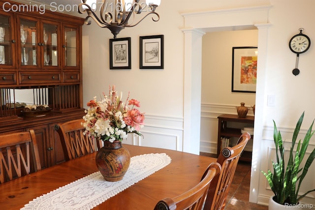 46877 W Ann Arbor Trl, Plymouth, MI 48170 - tiled dining area with a chandelier and a wainscoted wall