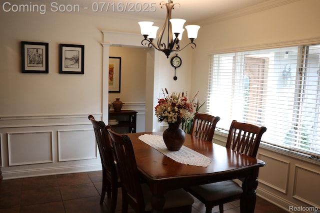46877 W Ann Arbor Trl, Plymouth, MI 48170 - dining area featuring a decorative wall, plenty of natural light, ornamental molding, a chandelier, and dark tile patterned floors