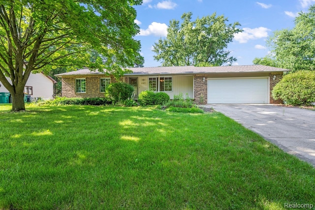 609 N Wickshire Ln, Durand, MI 48429 - ranch-style house featuring brick siding, driveway, a front yard, and an attached garage