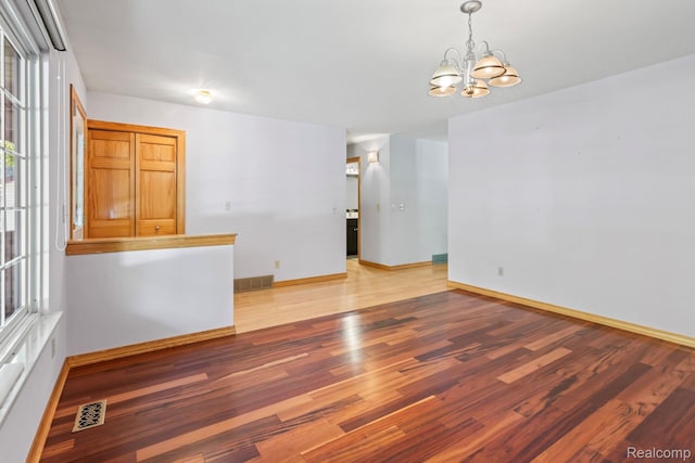 609 N Wickshire Ln, Durand, MI 48429 - empty room featuring a chandelier and light wood-type flooring