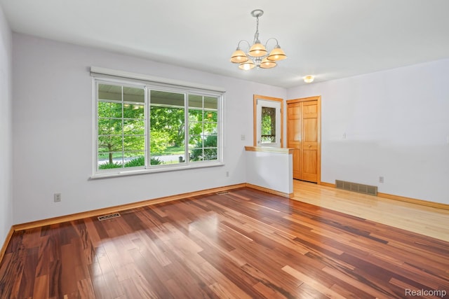 609 N Wickshire Ln, Durand, MI 48429 - empty room with a chandelier and wood finished floors