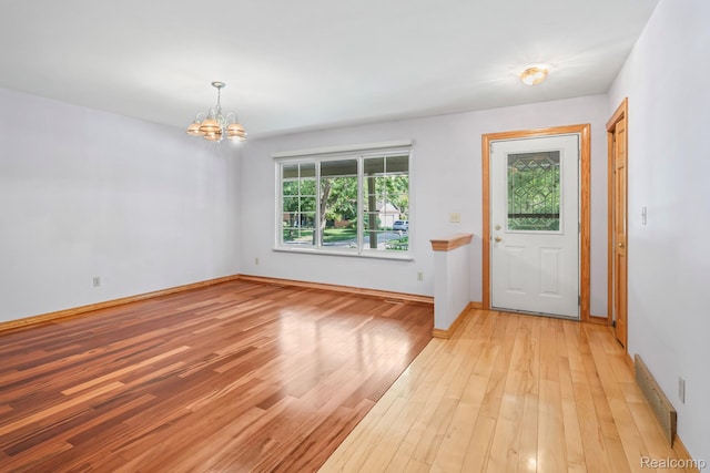 609 N Wickshire Ln, Durand, MI 48429 - foyer with a chandelier and light wood-type flooring