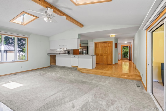 609 N Wickshire Ln, Durand, MI 48429 - unfurnished living room with a skylight, light colored carpet, and ceiling fan