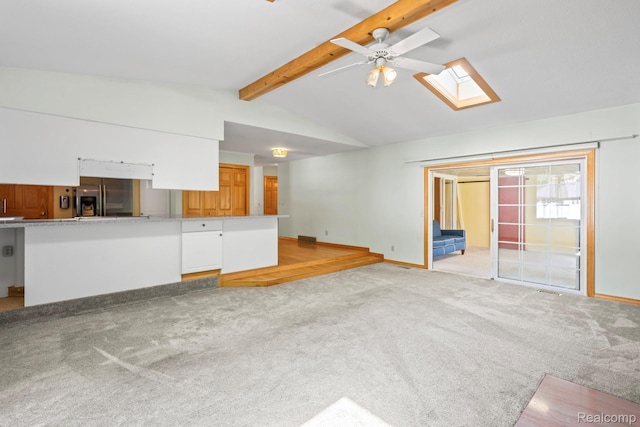 609 N Wickshire Ln, Durand, MI 48429 - unfurnished living room featuring a skylight, ceiling fan, and light carpet