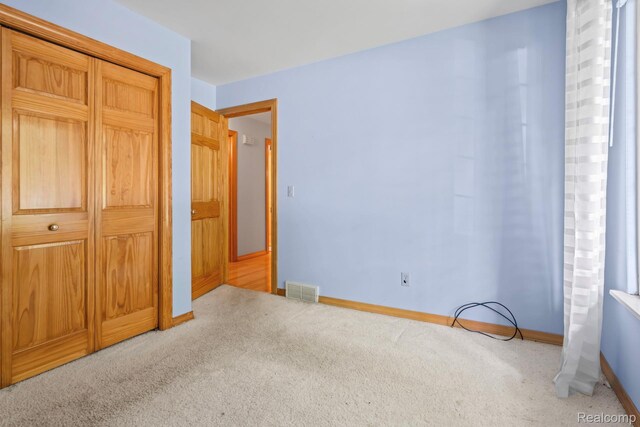 609 N Wickshire Ln, Durand, MI 48429 - unfurnished bedroom featuring carpet and a closet