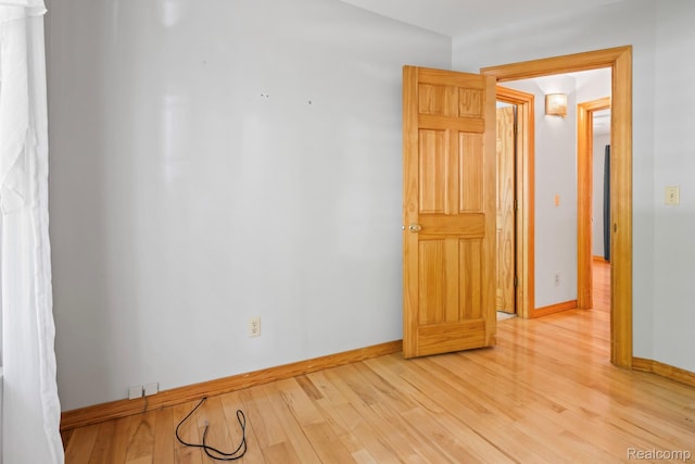 609 N Wickshire Ln, Durand, MI 48429 - unfurnished room with light wood-style flooring and baseboards