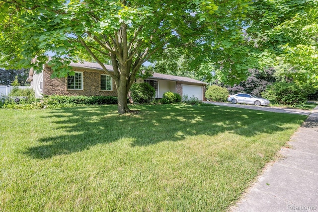 609 N Wickshire Ln, Durand, MI 48429 - view of front of house with an attached garage, brick siding, a front yard, and driveway