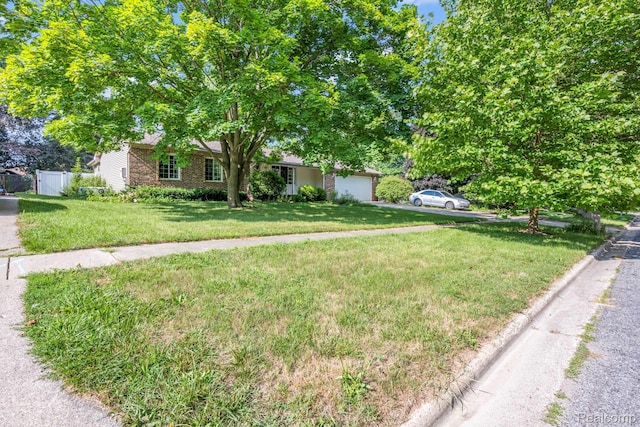 609 N Wickshire Ln, Durand, MI 48429 - view of property hidden behind natural elements with a garage and driveway
