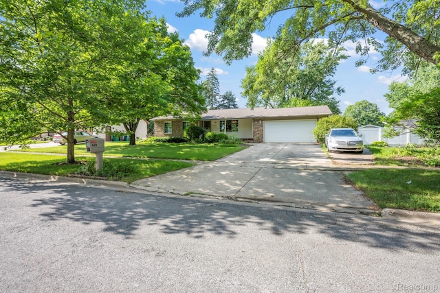 609 N Wickshire Ln, Durand, MI 48429 - single story home with a front lawn, an attached garage, driveway, and brick siding