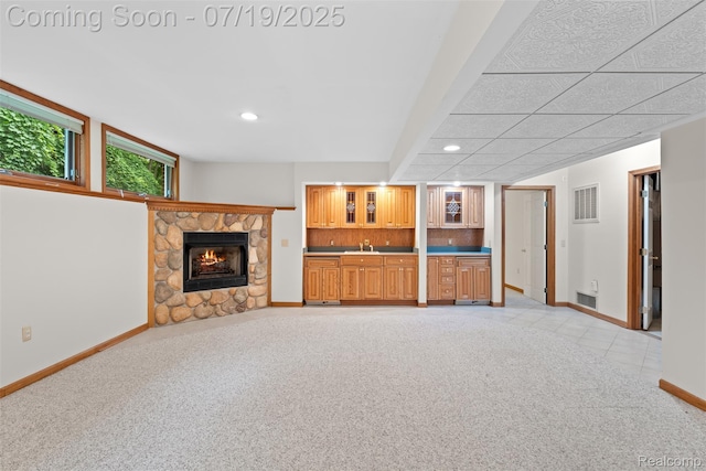 260 Forest Crest Dr, Commerce Twp, MI 48390 - unfurnished living room with wet bar, light colored carpet, a stone fireplace, and recessed lighting