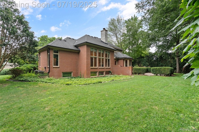 260 Forest Crest Dr, Commerce Twp, MI 48390 - back of property with brick siding, a chimney, and a lawn