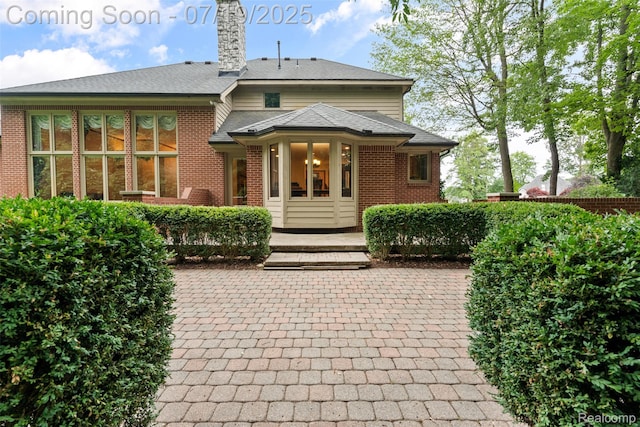 260 Forest Crest Dr, Commerce Twp, MI 48390 - back of house with brick siding and a chimney