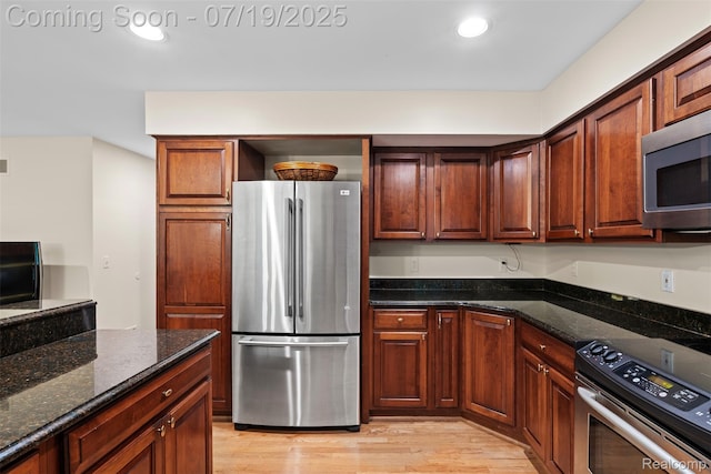 260 Forest Crest Dr, Commerce Twp, MI 48390 - kitchen with appliances with stainless steel finishes, light wood finished floors, dark stone counters, and recessed lighting