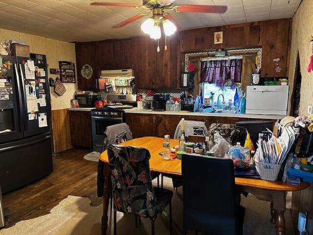 8210 E Pierce Rd, Hesperia, MI 49421 - kitchen with fridge with ice dispenser, range with gas stovetop, dark wood-type flooring, light countertops, and ceiling fan