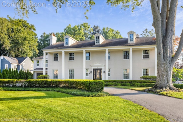 56 Oxford Rd, Grosse Pointe Shores, MI 48236 - greek revival inspired property featuring a front yard and a chimney