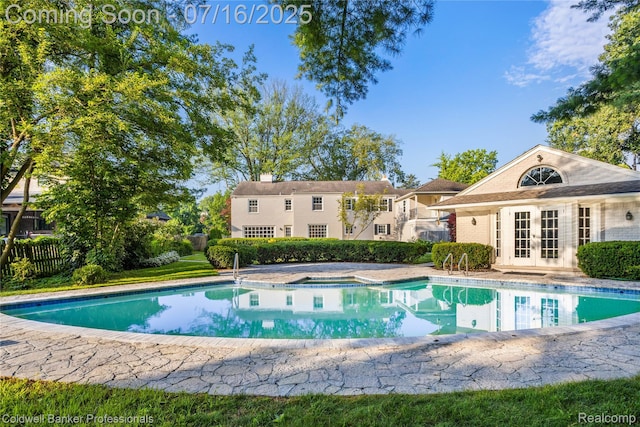 56 Oxford Rd, Grosse Pointe Shores, MI 48236 - swimming pool with french doors, a hot tub, and a patio area