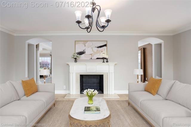 56 Oxford Rd, Grosse Pointe Shores, MI 48236 - living room featuring arched walkways, ornamental molding, a chandelier, and a fireplace with flush hearth
