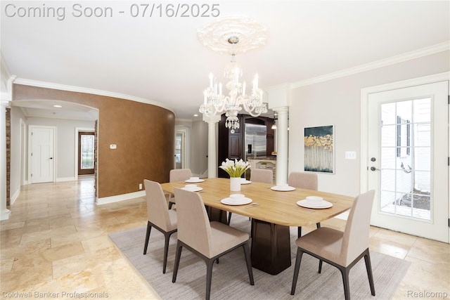 56 Oxford Rd, Grosse Pointe Shores, MI 48236 - dining space featuring arched walkways, ornate columns, crown molding, and a chandelier