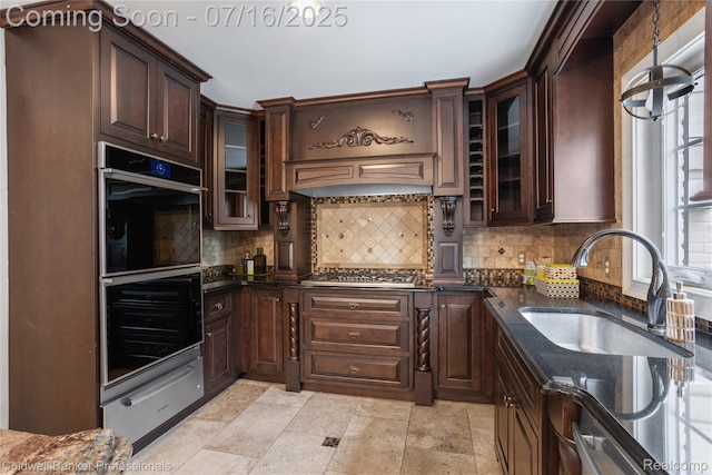 56 Oxford Rd, Grosse Pointe Shores, MI 48236 - kitchen featuring a warming drawer, dark stone countertops, tasteful backsplash, and dark brown cabinets