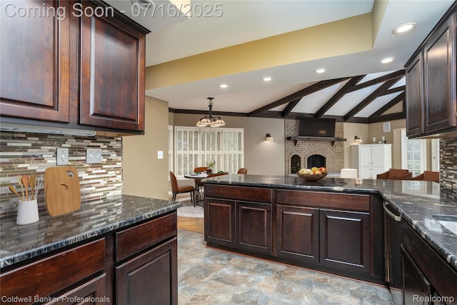 56 Oxford Rd, Grosse Pointe Shores, MI 48236 - kitchen with a brick fireplace, decorative backsplash, dark brown cabinetry, dark stone countertops, and recessed lighting