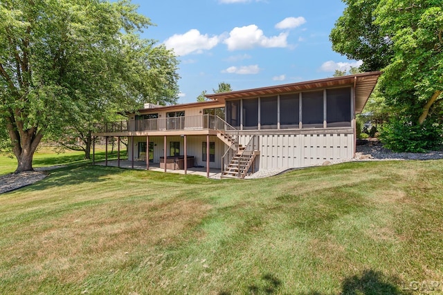 579 Budlong St, Adrian, MI 49221 - rear view of house with a sunroom, stairs, a deck, and a yard