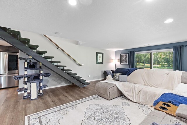 579 Budlong St, Adrian, MI 49221 - living room featuring stairs, wood finished floors, and recessed lighting