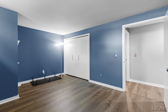 579 Budlong St, Adrian, MI 49221 - unfurnished bedroom with wood finished floors and a closet