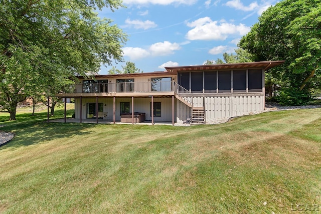 579 Budlong St, Adrian, MI 49221 - rear view of house with a hot tub, a sunroom, and a yard