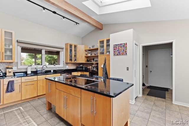579 Budlong St, Adrian, MI 49221 - kitchen featuring a skylight, black electric cooktop, a center island, and tasteful backsplash
