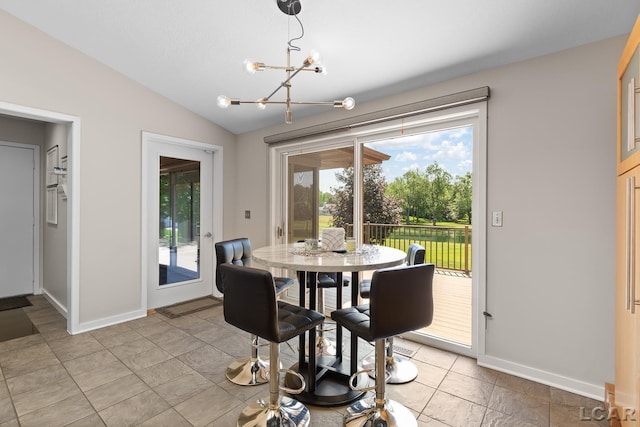 579 Budlong St, Adrian, MI 49221 - dining area with a chandelier, healthy amount of natural light, and vaulted ceiling