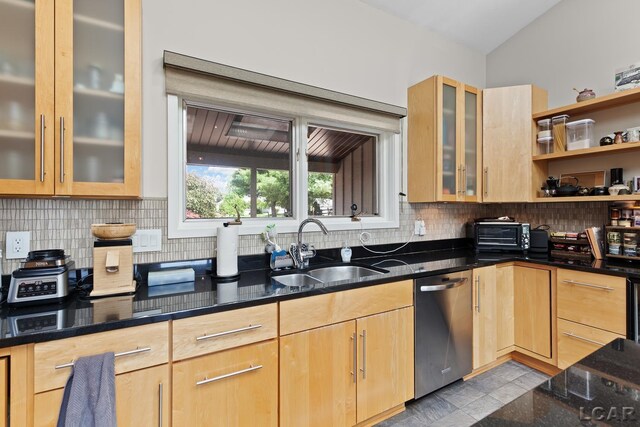 579 Budlong St, Adrian, MI 49221 - kitchen with stainless steel dishwasher, dark stone countertops, light brown cabinets, backsplash, and glass insert cabinets