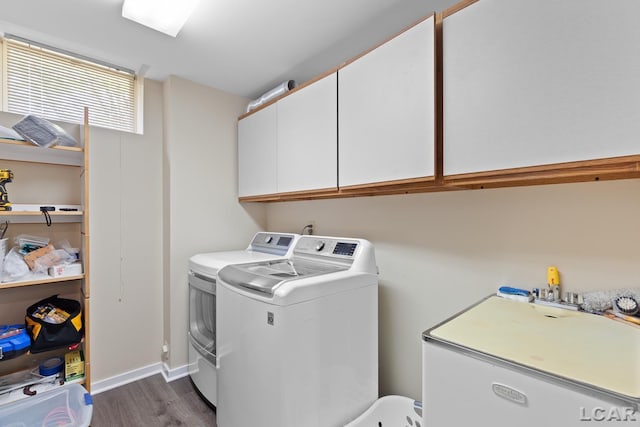 579 Budlong St, Adrian, MI 49221 - laundry room featuring cabinet space, dark wood finished floors, and separate washer and dryer