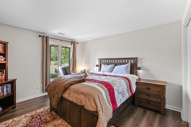 579 Budlong St, Adrian, MI 49221 - bedroom featuring dark wood-style flooring and access to exterior