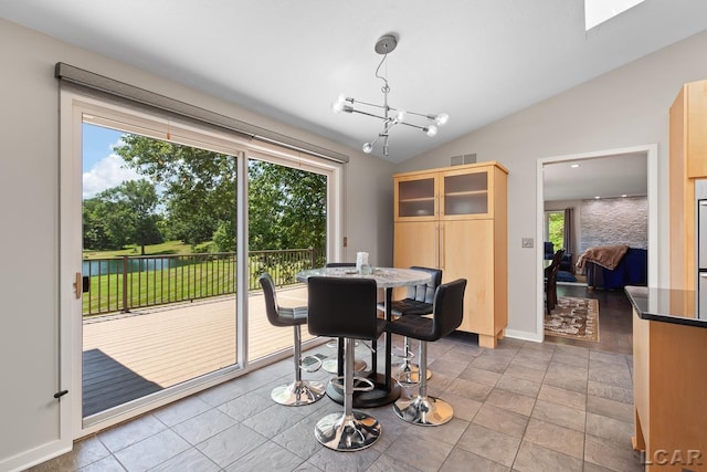 579 Budlong St, Adrian, MI 49221 - dining space with healthy amount of natural light, vaulted ceiling, and a chandelier