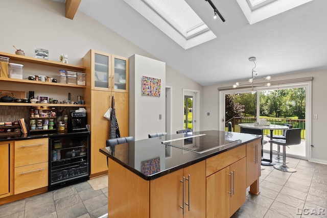 579 Budlong St, Adrian, MI 49221 - kitchen featuring black electric cooktop, lofted ceiling, beverage cooler, a center island, and glass insert cabinets