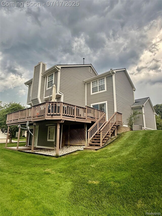 31199 Columbia Dr, Novi, MI 48377 - rear view of property featuring a deck and a lawn