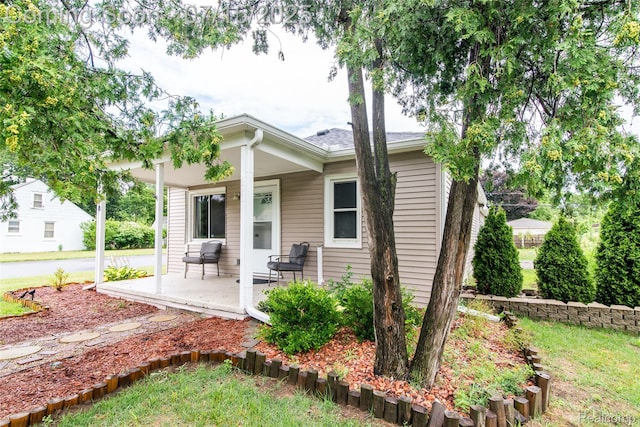 5758 N Parent St, Westland, MI 48185 - rear view of property featuring covered porch and a lawn