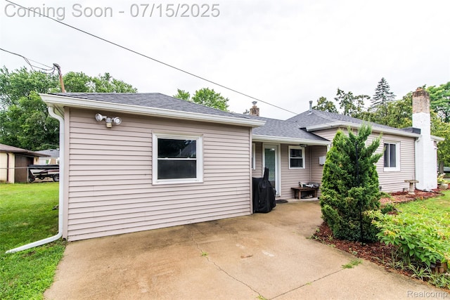 5758 N Parent St, Westland, MI 48185 - view of front of home with a patio area, a chimney, a front lawn, and roof with shingles