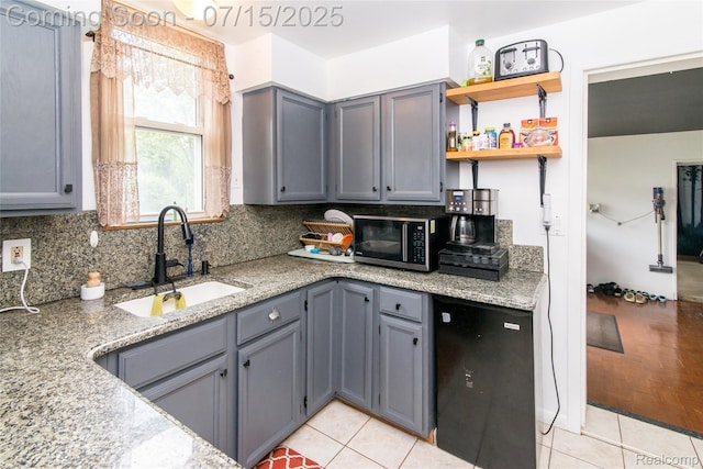 5758 N Parent St, Westland, MI 48185 - kitchen featuring stainless steel microwave, gray cabinetry, tasteful backsplash, and light stone counters