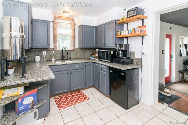 5758 N Parent St, Westland, MI 48185 - kitchen featuring stainless steel microwave, tasteful backsplash, light tile patterned floors, open shelves, and light stone countertops