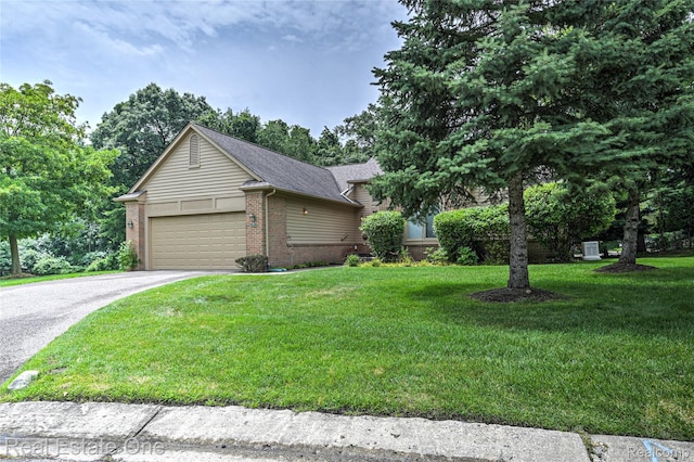 7071 Deerwood Trl Unit 28, West Bloomfield, MI 48323 - view of front facade with brick siding, driveway, a front yard, a garage, and roof with shingles