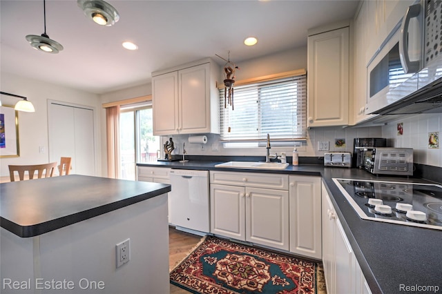 7071 Deerwood Trl Unit 28, West Bloomfield, MI 48323 - kitchen featuring white appliances, dark countertops, white cabinets, and recessed lighting