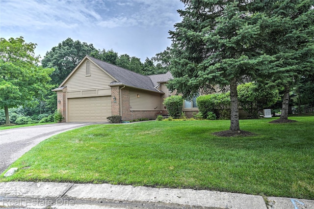 7071 Deerwood Trl Unit 28, West Bloomfield, MI 48323 - view of front of house featuring brick siding, driveway, a garage, and a front lawn