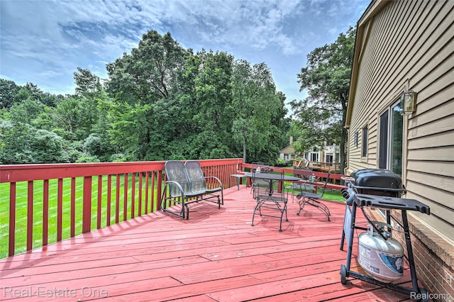 7071 Deerwood Trl Unit 28, West Bloomfield, MI 48323 - deck featuring outdoor dining space, a lawn, and view of scattered trees