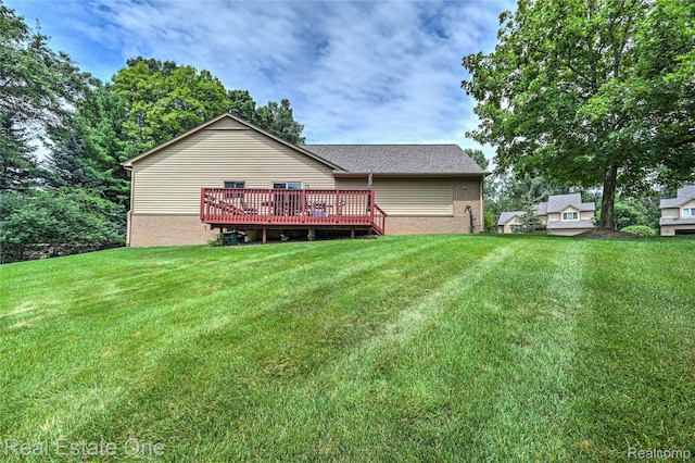 7071 Deerwood Trl Unit 28, West Bloomfield, MI 48323 - rear view of house featuring a yard, a deck, and brick siding