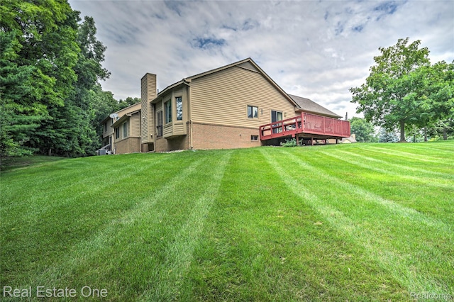 7071 Deerwood Trl Unit 28, West Bloomfield, MI 48323 - back of house with a chimney, a lawn, and a wooden deck