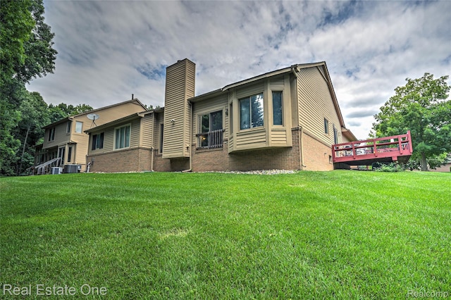 7071 Deerwood Trl Unit 28, West Bloomfield, MI 48323 - back of house with a chimney, brick siding, a lawn, and a deck